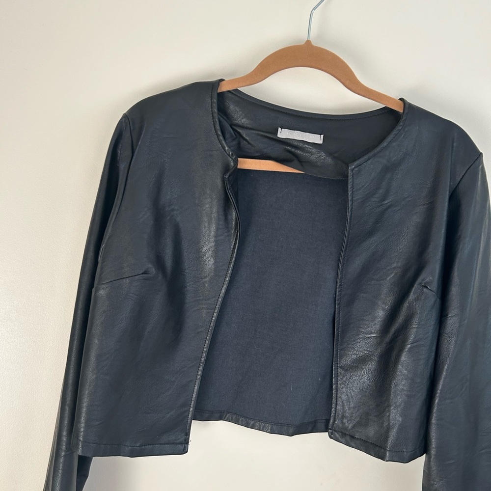black faux leather crop jacket.